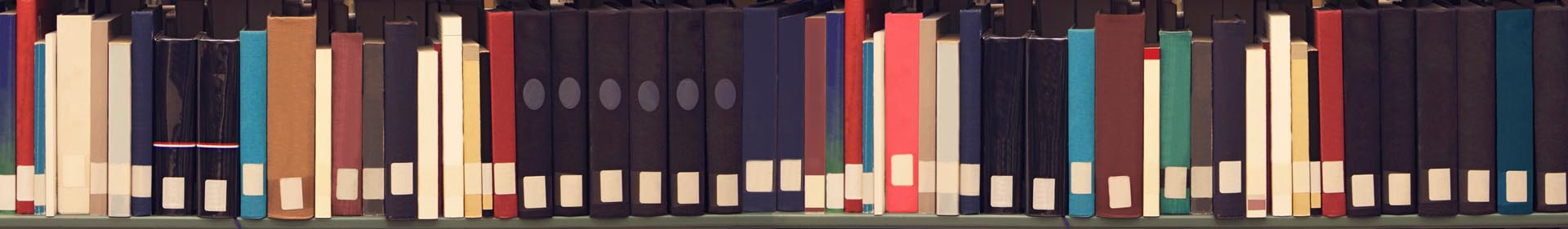 Library shelf of many books lined up.