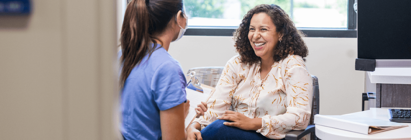 Nurse sitting with a patient at the doctor's office.