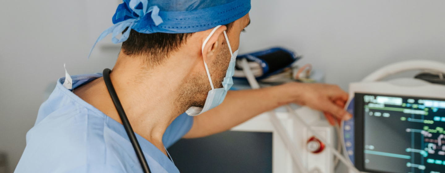 Image of a healthcare professional checking a monitor.