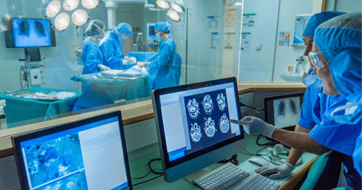 Surgeon and doctors monitoring brain scans and on the operating table.