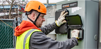 Image of a worker turning on a generator.