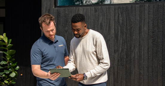 Generac technician giving an in-home consultation to EV owner