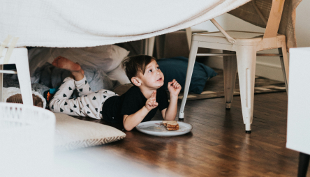 Child under a homemade fort